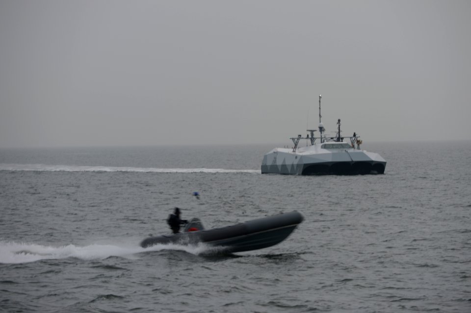 A small boat passes the experimental Stiletto. (8456177696)