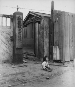 A small South Korean child sits alone in the street, after elements of the 1st Marine Division and South Korean... - NARA - 531374 photo