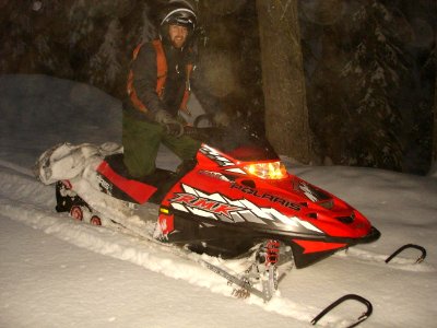 A snowmobiler traveling in the dark (39609485815)
