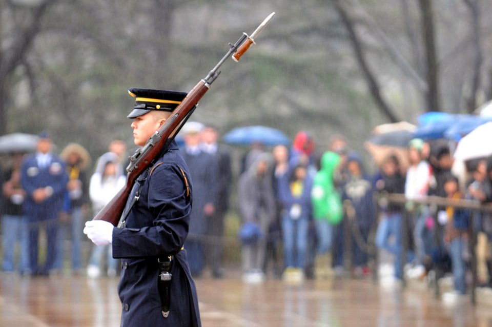 A Soldier guards the Tomb of the Unknowns as National Guard officers accompany members of the Senate Youth Program