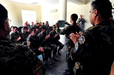 A soldier with the Afghan National Army Air Corps, holds up his graduation certificate (4550816192)