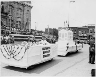 A Southwest Baptist Float passes in front of the reviewing platform (in the distance) on which President Harry S.... - NARA - 199909