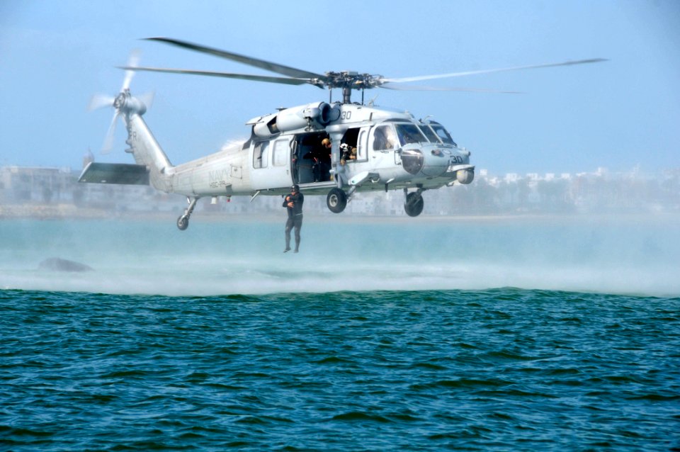 A Spanish marine casts out of a U.S. Navy SH-60S Sea Hawk helicopter. (16764710362)
