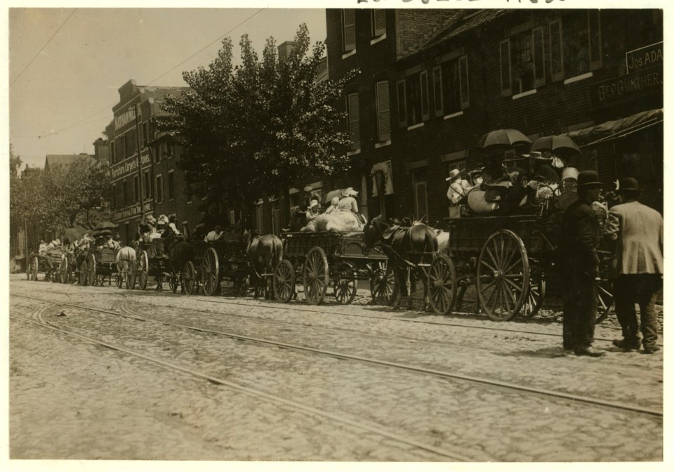 A street full of Baltimore immigrants lined up and ready to start for the country to the berry farms. Wolfe Street, near Canton Avenue, Baltimore, Maryland. Courtesy of Maryland Child Labor LOC cph.3b46648