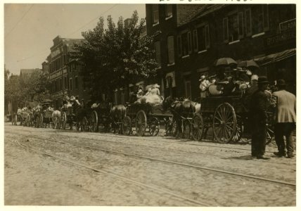A street full of Baltimore immigrants lined up and ready to start for the country to the berry farms. Wolfe Street, near Canton Avenue, Baltimore, Maryland. Courtesy of Maryland Child Labor LOC cph.3b46648
