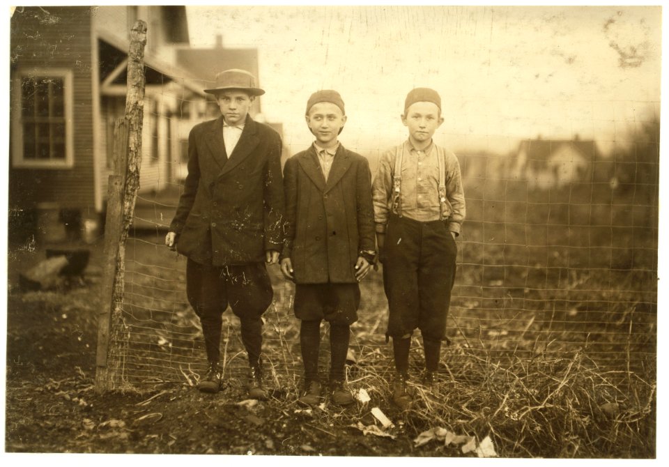 A study of ages. The boy on the right said, 'I ain't old enough to work in the mill; I am ten years.' The boy in the middle, Buford Fox who has been working in the Merrimack Mills for one LOC nclc.02883