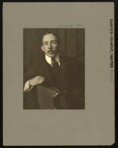 Alberto Santos-Dumont, half-length portrait, facing front, sitting, with right arm resting on back of chair LCCN2008676779