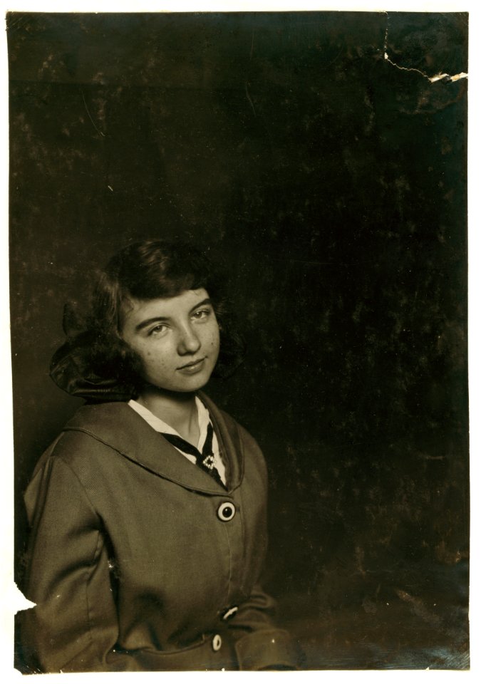 Aldea Balanger - French - Weaver. Cornell Mills - 14 years old July 12, 1915, getting her certificate for her 5th position. Face broken out as most of weavers have from the machine oil, LOC nclc.03068