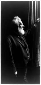 Alexander Graham Bell, three-quarter length portrait, standing, facing right, by window LCCN93515341