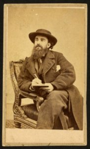 Alfred Waud, full-length portrait, seated, holding a pencil and pad, facing left LCCN2009631311