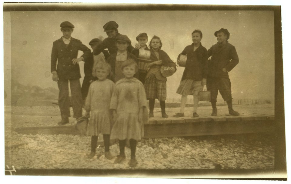 All are workers in a Pass Christian oyster cannery. Going home at 5 P.M. The youngest ones shuck before and after school. Two youngest are Lillie and Sadie Bilski, 8 and 6 years old. They LOC nclc.01035