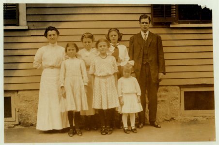 All of the family of Antoinette Pothier, 32 Easton Street, (See 2477). Father and tallest girl in back row of the picture work. Antoinette is the center of the group in the front row. Her LOC nclc.02346