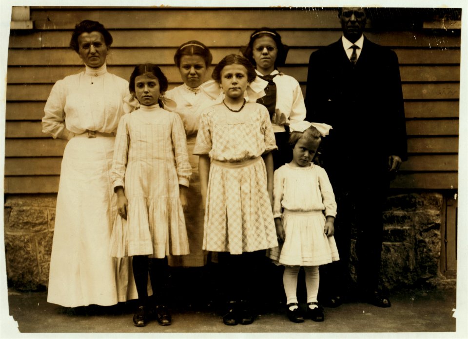 All of the family of Antoinette Pothier, 32 Easton Street. Father and tallest girl in back row of the picture work. Antoinette is the center of the group in the front row. Her sister Anita LOC nclc.02347
