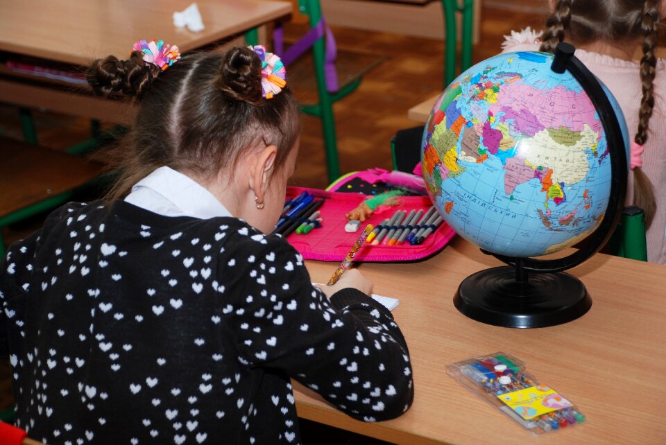 Girl study globe photo