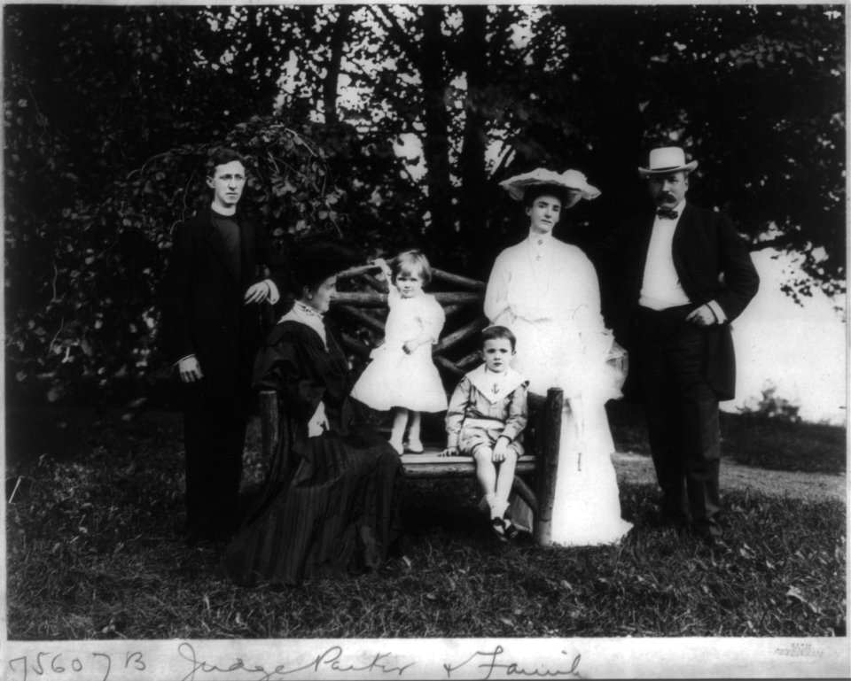 Alton Brooks Parker, 1852-1926, full length, standing, facing slightly left; with family, incl. wife, son-in-law in clerical robe; step-daughter, and 2 grandchildren, on lawn LCCN2005686644
