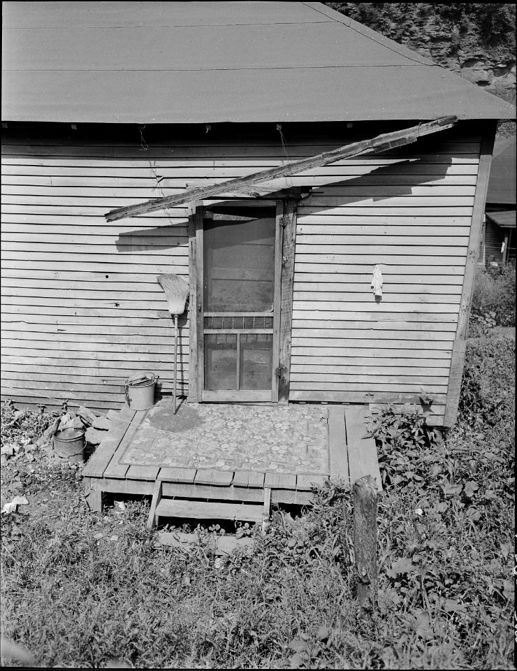 Back door of a house. The screening is supplied by the employee-tenant. The Company is responsible for outside... - NARA - 541038