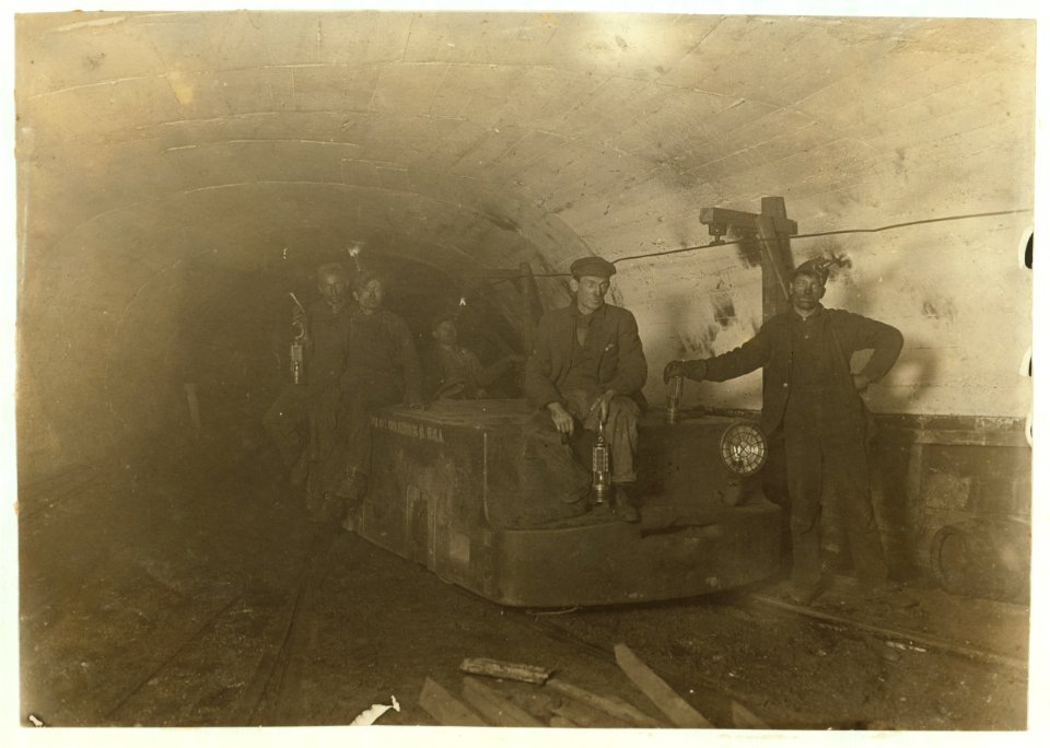 Bank boss, (with lamp between knees) Motorman, Brake-boy and Driver. Gary Mine, Gary, W. Va. Boss said he would use more boys if he could get them but they went to school. Note live wire on LOC nclc.01056