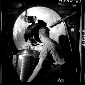 Barbette of 16 gun on board the USS New Jersey (BB-62). Gunner lowers breech block preparatory to loading grant shell. - NARA - 520876