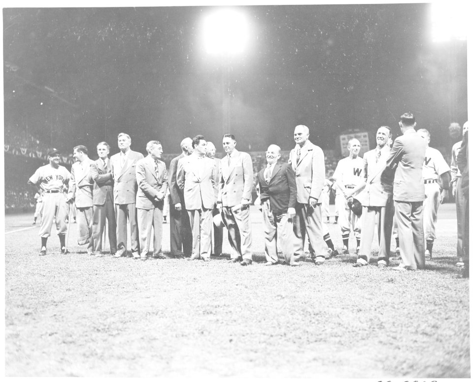 Baseball players and unidentified men gathered on the field of Griffith Stadium. President Harry S. Truman was in... - NARA - 199865