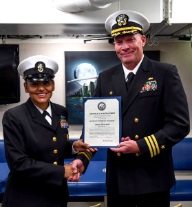 170427 - CAPT Fortson gives CMDCM Veronica Holliday reenlistment certificate