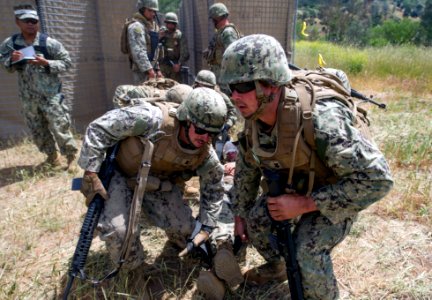 170514-N-XJ502-082 - Seabees assigned to Naval Mobile Construction Battalion (NMCB) 4 perform a six-man litter carry