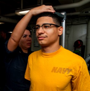 171120-N-BD308-0017 - SH2 Carmen Zela measures MC3 Michael Molina during BCA aboard USS Wasp
