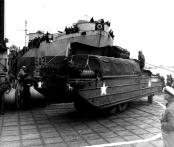 US GMC DUKW-353 unloading from landing ship LST-543 Berthed at a pier called a Mulberry harbour June 1944. (49689695663)