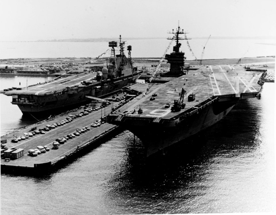 USS NIMITZ (CVN-68) and HMS ARK ROYAL (R09)) Berthed at the Norfolk Naval Base, Virginia, in April 1976. They are dressed with flags in honor of the birthday of Queen Juliana of the Netherlands (49524705733)