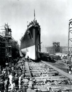 USS Huntington feels water for the first time as her hull slides into the Delaware river at the New York Shipbuilding Corporation in Camden, New Jersey, 8 April 1945. (48230241177)