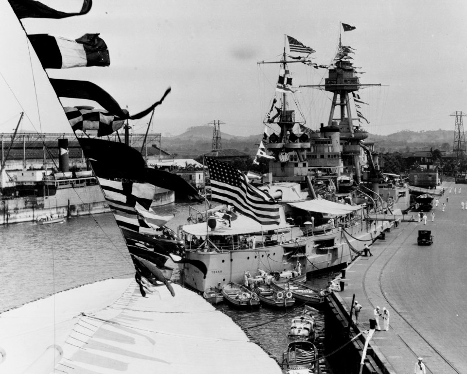 USS Texas (BB-35) Docked at Balboa, Canal Zone, circa 1931. She is dressed with flags for some occasion, and is flying a 4-star Admiral's flag. (51001150419)