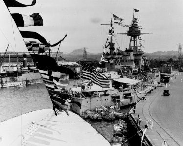 USS Texas (BB-35) Docked at Balboa, Canal Zone, circa 1931. She is dressed with flags for some occasion, and is flying a 4-star Admiral's flag. (51001150419)