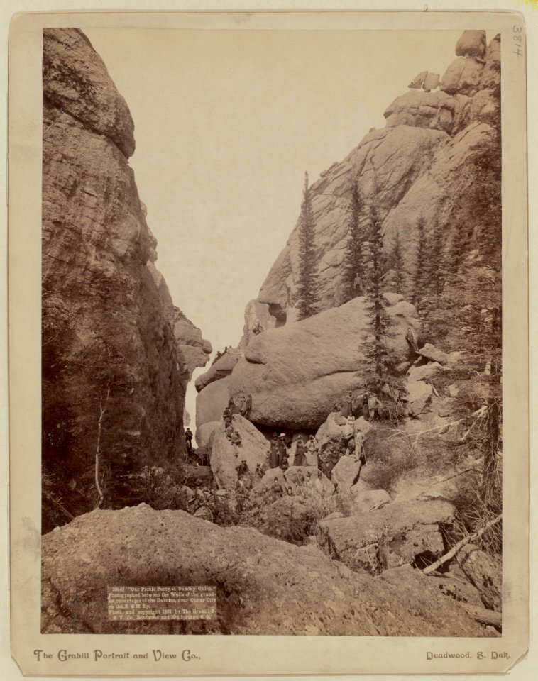 Our picnic party at Sunday Gulch. Photographed between the walls of the grandest mountains of the Dakotas, near Custer City on the B. & M. Ry - The Grabill Portrait and View Co., Deadwood, LCCN99613945