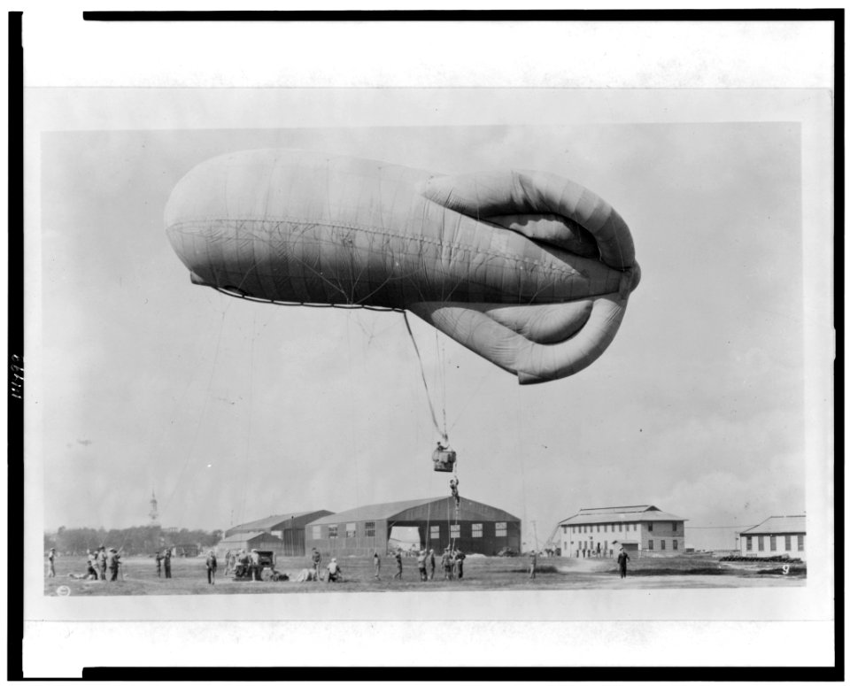 Pilot climbing up rope to get into basket (gondola) suspended below observation kite balloon during training at the U.S. Naval Air Station, Hampton Roads, Virginia LCCN94511813