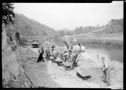 Pouring the first batch of concrete for Crib ^1 on the heavy duty construction bridge at Norris Dam site, just below... - NARA - 532708