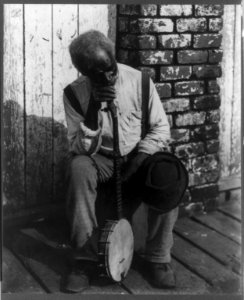 Retrospection. Old Negro man sitting and leaning on his banjo LCCN2006687460