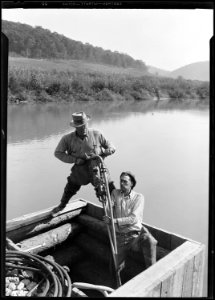 Rock-driller and helper drilling in rock under water at Norris Dam site. - NARA - 532674
