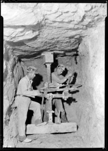 Rock-drillers working in lateral shaft at base of Norris Dam site. - NARA - 532679