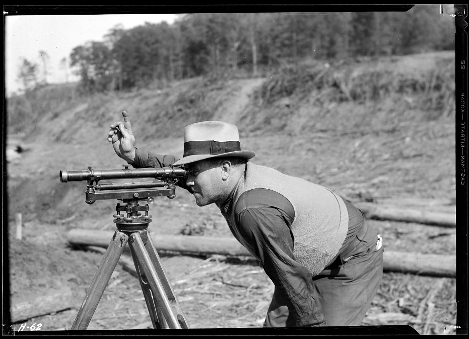 S. P. Graves, instrument man, working on new construction bridge at Norris Dam. - NARA - 532685
