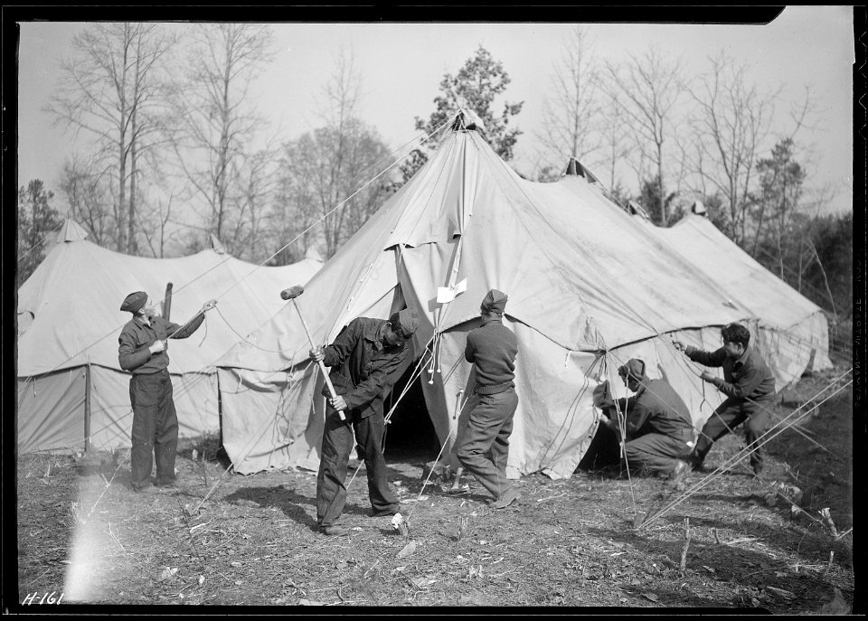 Setting up a sleeping tent at CCC Camp, TVA ^22, near Esco, Tennessee, to accommodate replacements who arrived from... - NARA - 532779