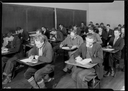 Skilled and unskilled laborers taking the TVA examination at the highschool building, Clinton, Tennessee. - NARA - 532813 photo