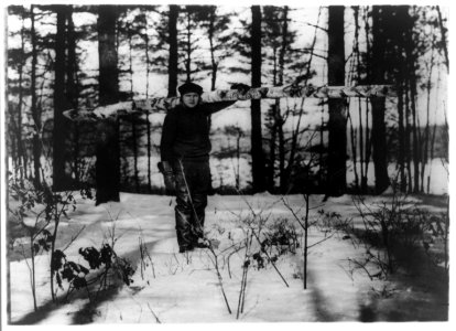Babe Ruth carrying a 300 pound log for the stove, in snow LCCN92514554