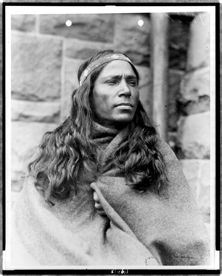 Baby Lone, Kickapoo medicine man, half-length portrait, facing right, wrapped in blanket LCCN97512090