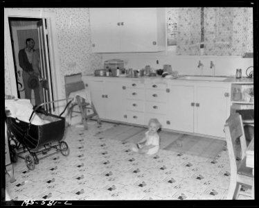 Baby of Boyd Lindsay, miner, in kitchen of his home in company housing project. Utah Fuel Company, Sunnyside Mine... - NARA - 540502 photo