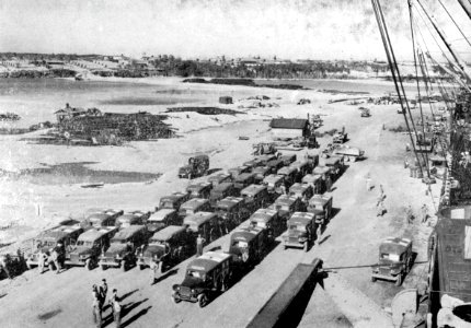 Ambulances wait for wounded to be transferred USS Sanborn (APA-193) at Guam, circa in February 1945