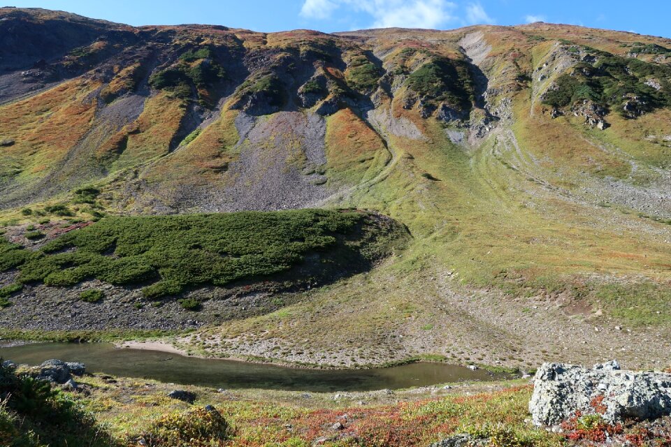 Stone wall rock slides mountain valley