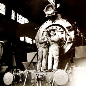 American and British engineers on American train engine somewhere in Iran, 1943 (24839966600)