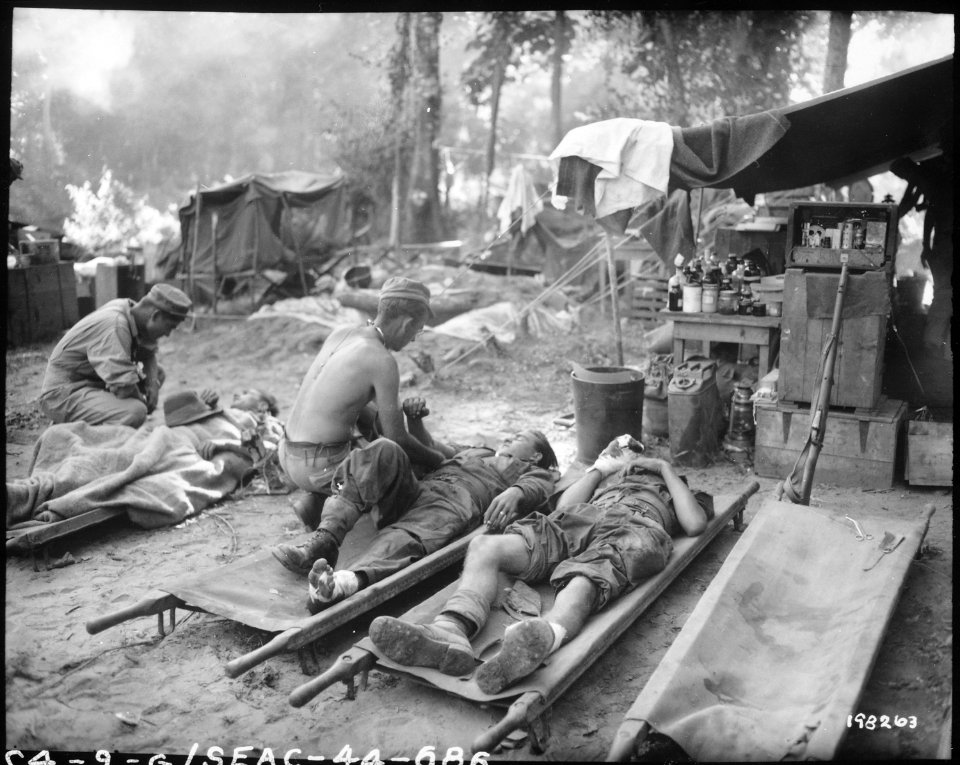 American medics treat casualties at an American portable surgical unit during the 36th Division drive on Pinwe, Burma. - NARA - 531238