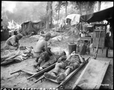 American medics treat casualties at an American portable surgical unit during the 36th Division drive on Pinwe, Burma. - NARA - 531238