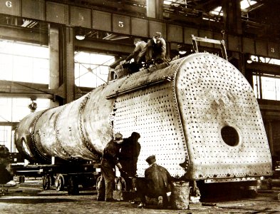 American railroad men work on firebox and boiler of a big transcontinental U.S. locomotive, WWII (34624747601)