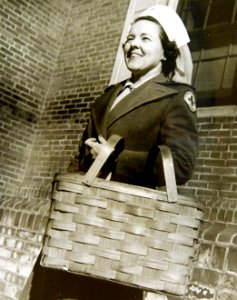 American Red Cross Recreation Unit volunteer carries equipment in a basket, WWII (34756220775)